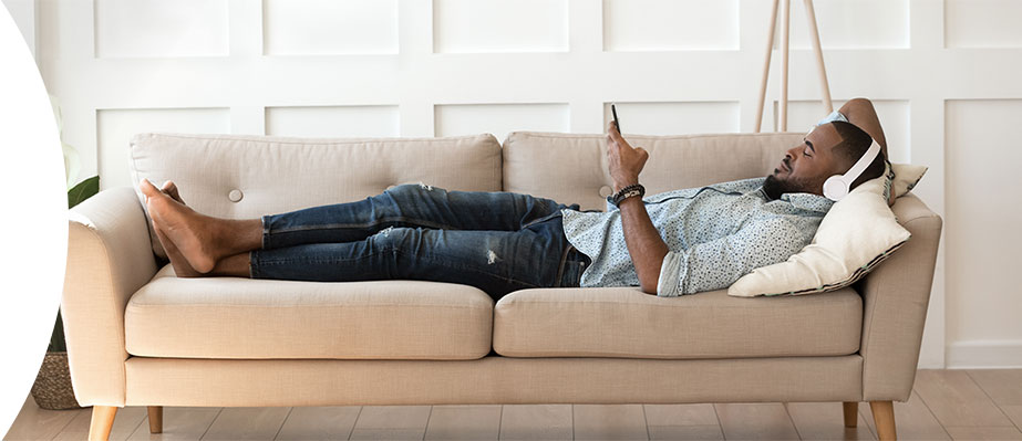 Person relaxing on a sofa.