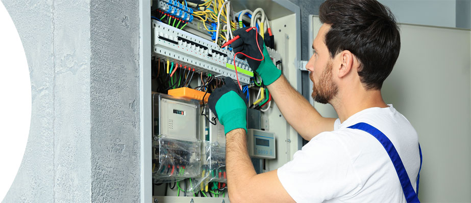 Electrician working on an electrical panel.